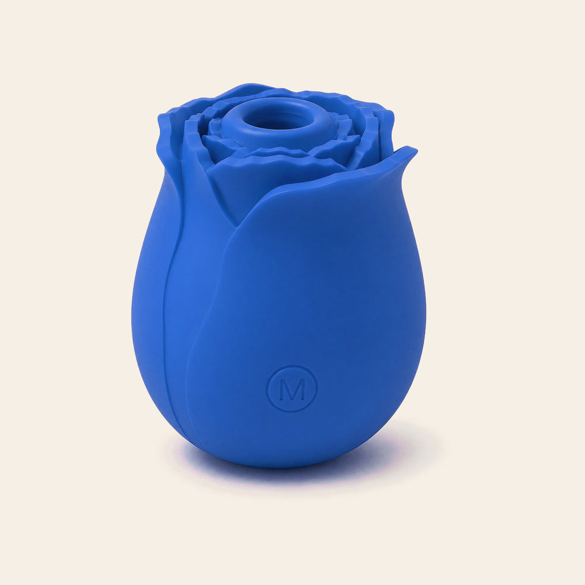Rose-shaped silicone clitoral suction vibrator in blue on a soft beige background — Femme Bliss BloomPulse Rose