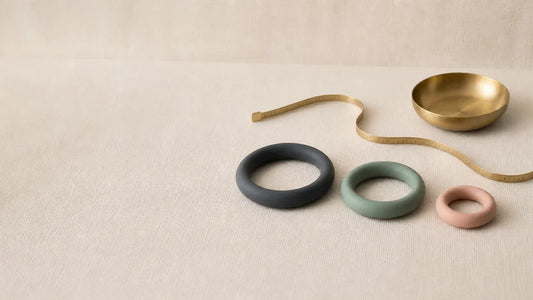 Three silicone rings in graduated diameters beside a measuring tape, a cock ring size guide to fit and safe wear time