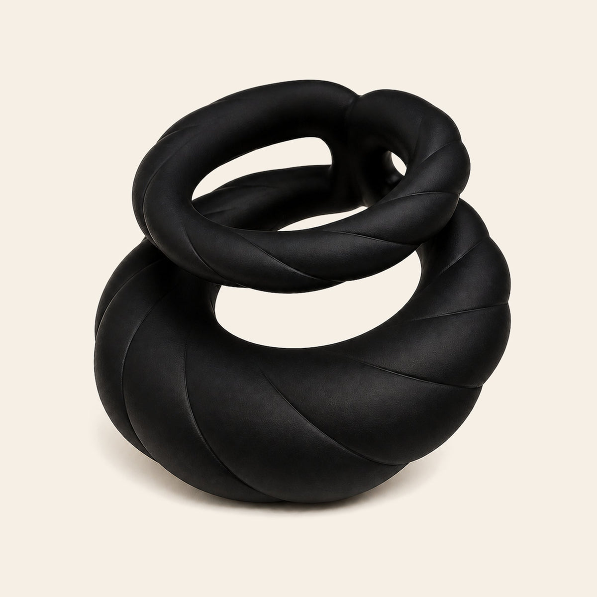 Black silicone dual-motor vibrating cock ring with coiled bands on a soft beige background — Femme Bliss PulseForge Duo