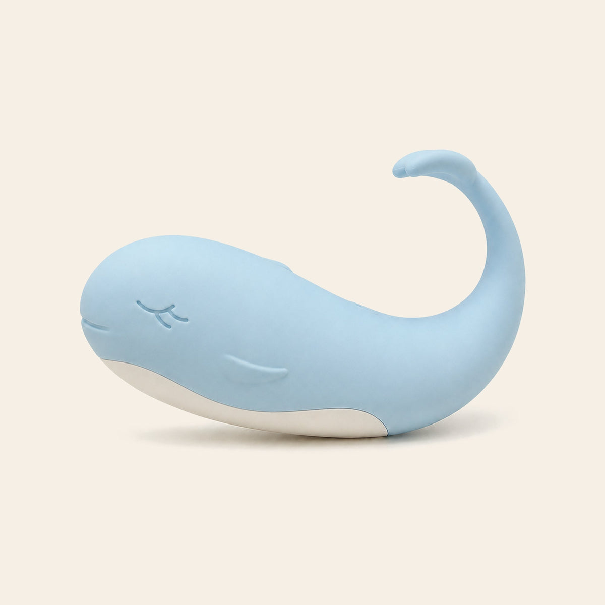 Pale blue whale-shaped silicone wearable vibrating egg on a soft beige background — Femme Bliss TidalBliss