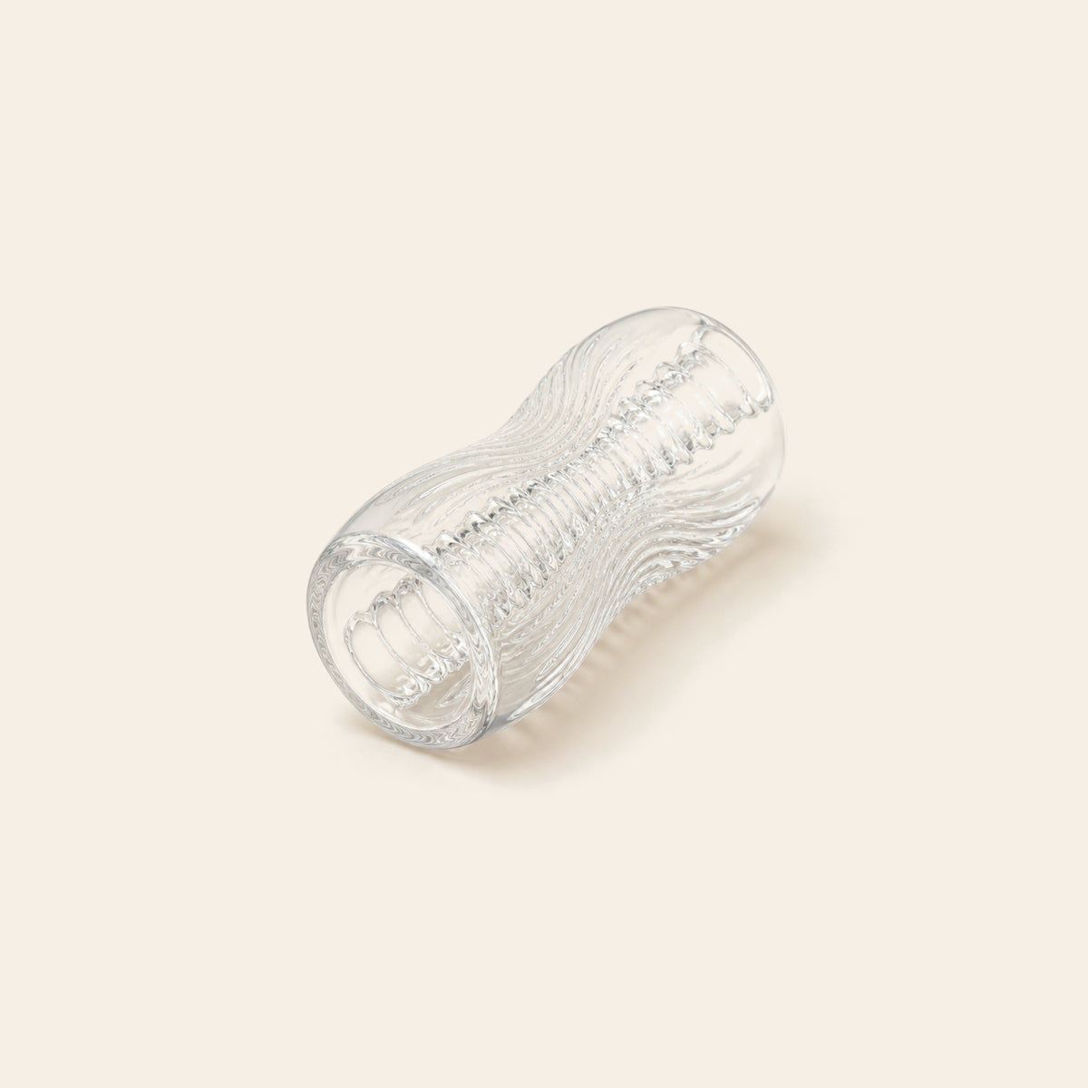 Transparent TPE stroker with a spiralled internal texture on a soft beige background — Femme Bliss Crystal Touch