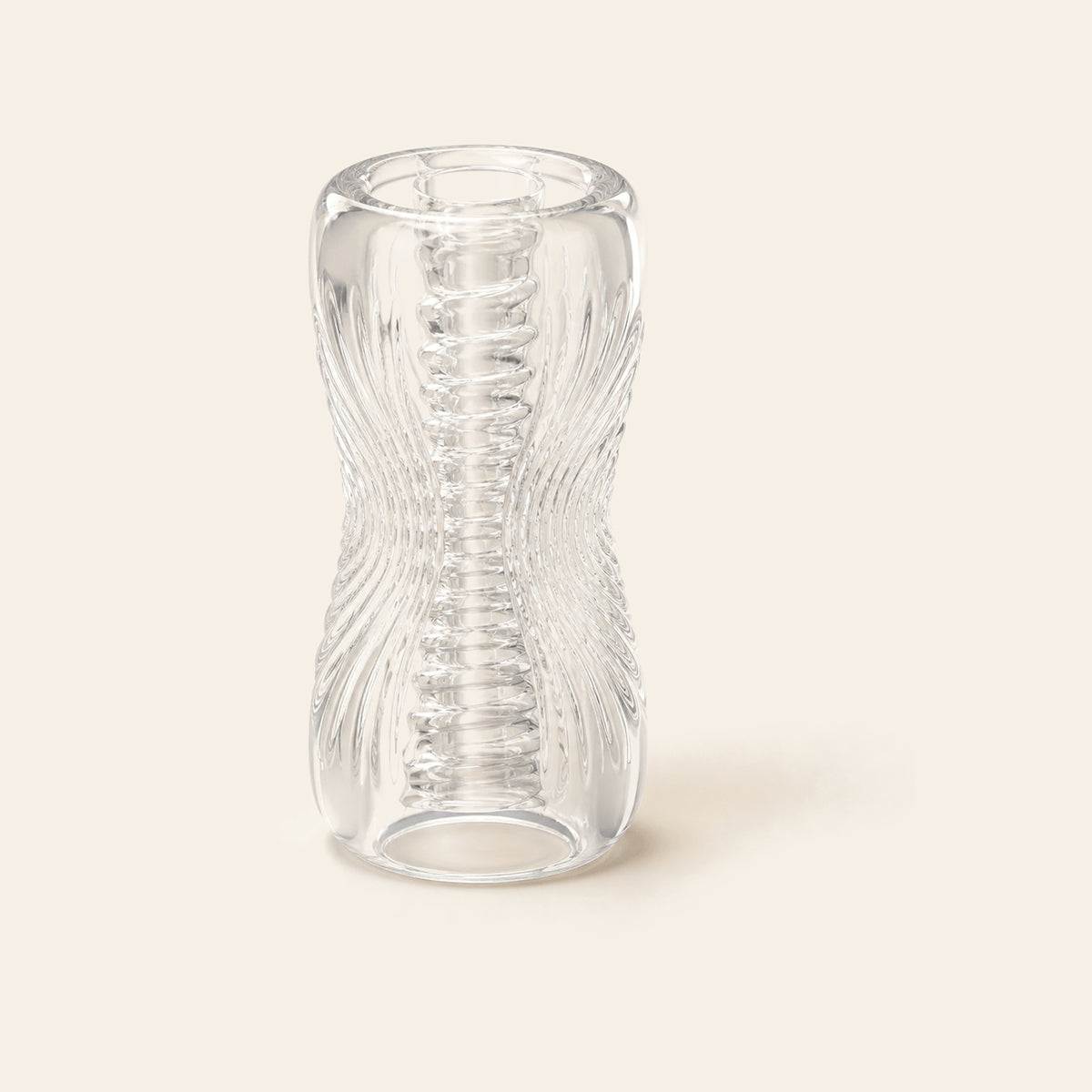 Transparent TPE stroker shown at an angle, the ribbed and nubbed canal visible through the clear wall