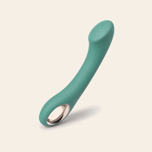 Curved G-spot vibrator in green with a rose-gold base ring, on a soft beige background — Femme Bliss Velvet Pulse