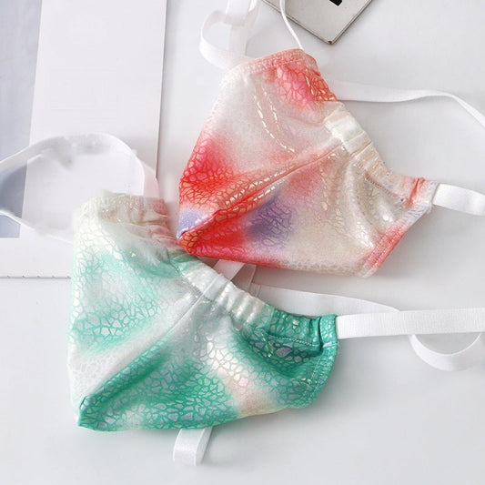 Two open-back thongs in iridescent red and iridescent green, pouches overlapping, white elastic straps — Femme Bliss Faux Leather Thong