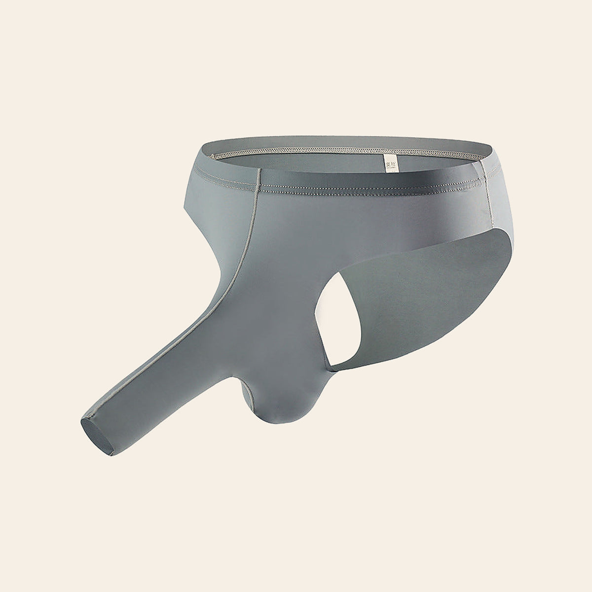 Men's breathable contour thong brief in grey with a 3D pouch and open cutout, on a soft beige background — Femme Bliss AeroLuxe Edge