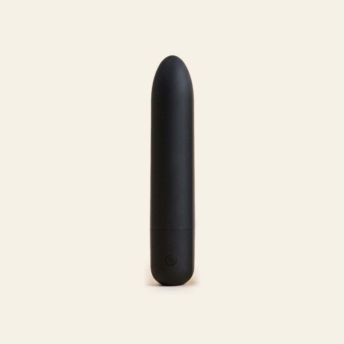 Matte black bullet vibrator with a single button at the base, on a soft beige background — Femme Bliss Bliss Bullet