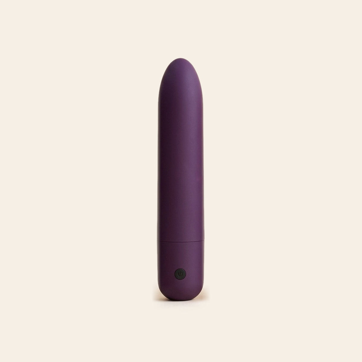 Matte deep purple bullet vibrator with a single button at the base, on a soft beige background — Femme Bliss Bliss Bullet