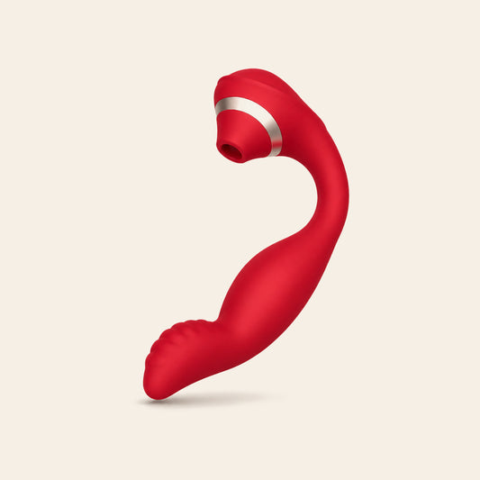 Red dual-stimulation rabbit vibrator with suction head and silver band on a soft beige background — Femme Bliss BlissWave Duo