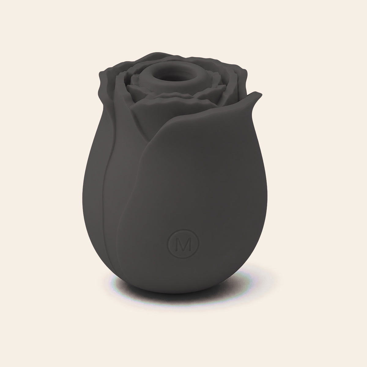 Rose-shaped silicone clitoral suction vibrator in black on a soft beige background — Femme Bliss BloomPulse Rose