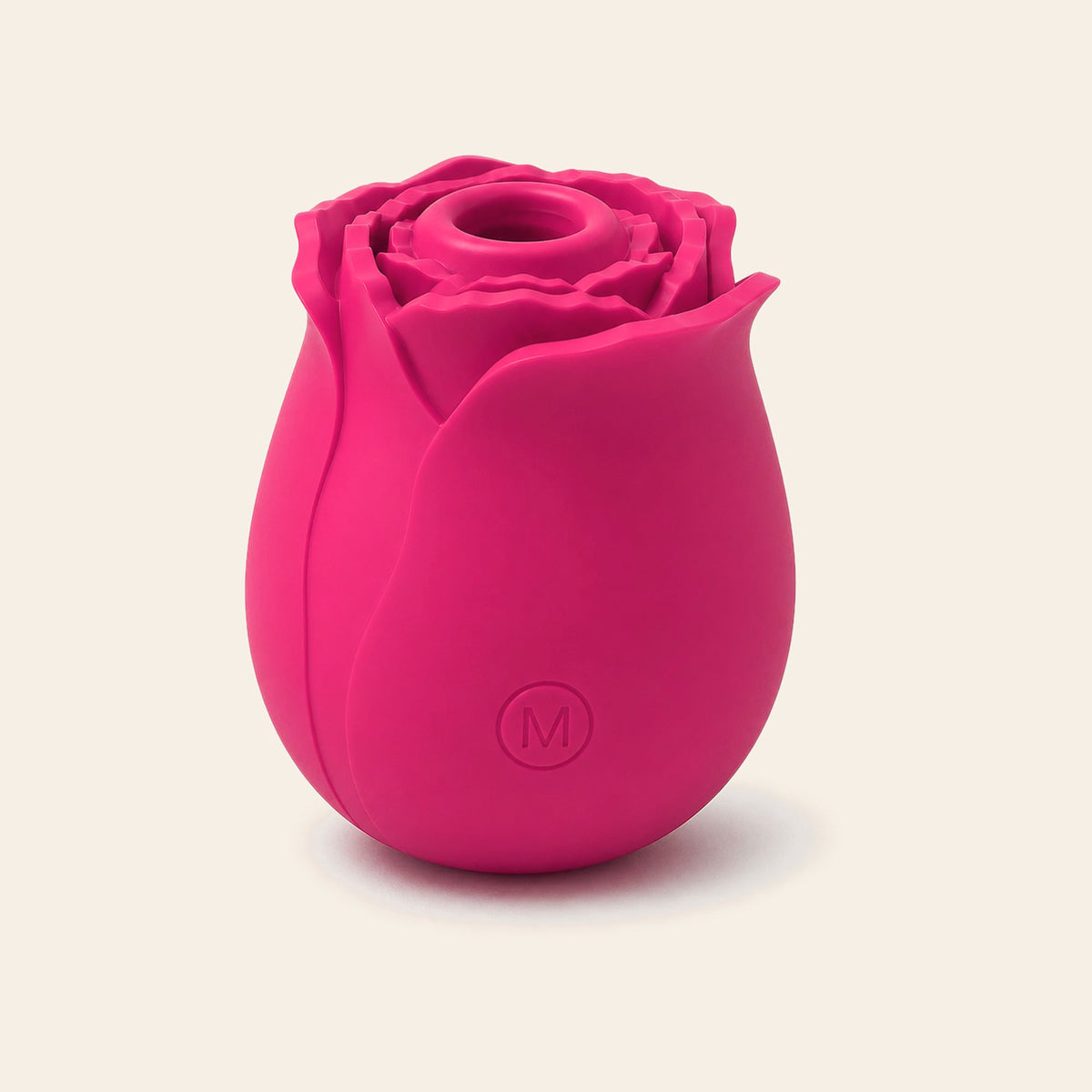 Rose-shaped silicone clitoral suction vibrator in rose red on a soft beige background — Femme Bliss BloomPulse Rose
