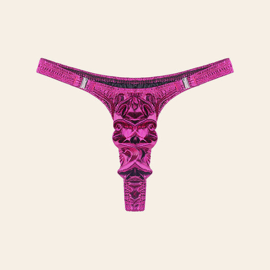 Men's high-shine metallic thong in fuchsia with a contoured pouch and slim side straps, on a soft beige background — Femme Bliss Lustre Edge