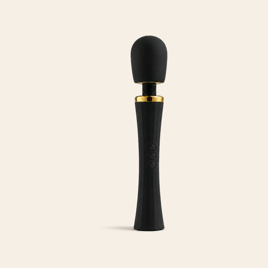 LuxePower Wand rechargeable massager in black with a gold band, rounded silicone head and flexible neck, on a beige background