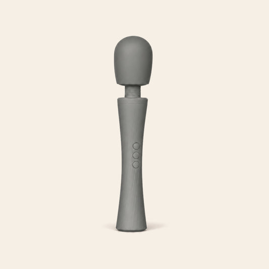 LuxePower Wand rechargeable massager in grey with a rounded silicone head and flexible neck, on a beige background