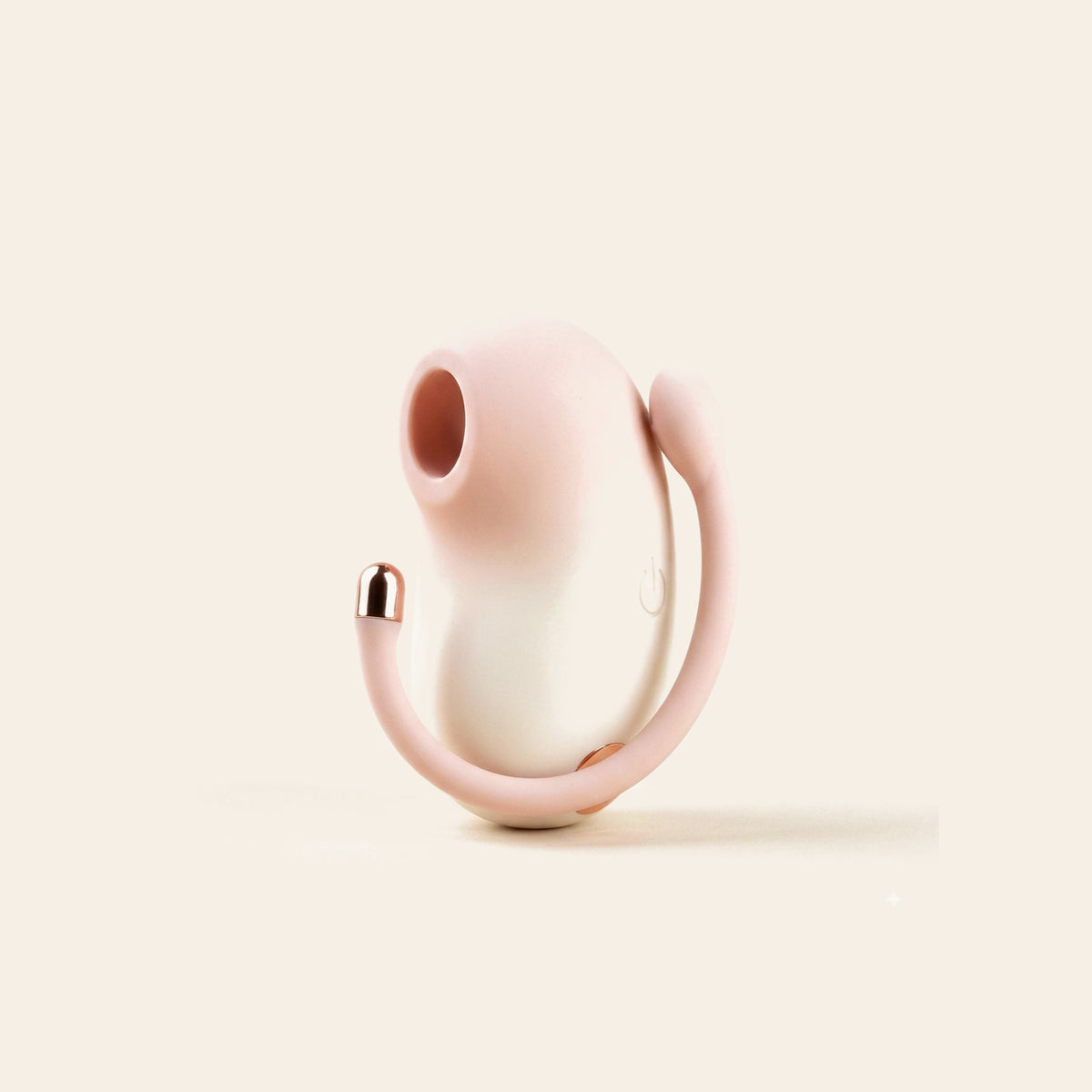 Cream wearable suction and vibration egg with rose-gold tip on a soft beige background — Femme Bliss PodPulse Bean