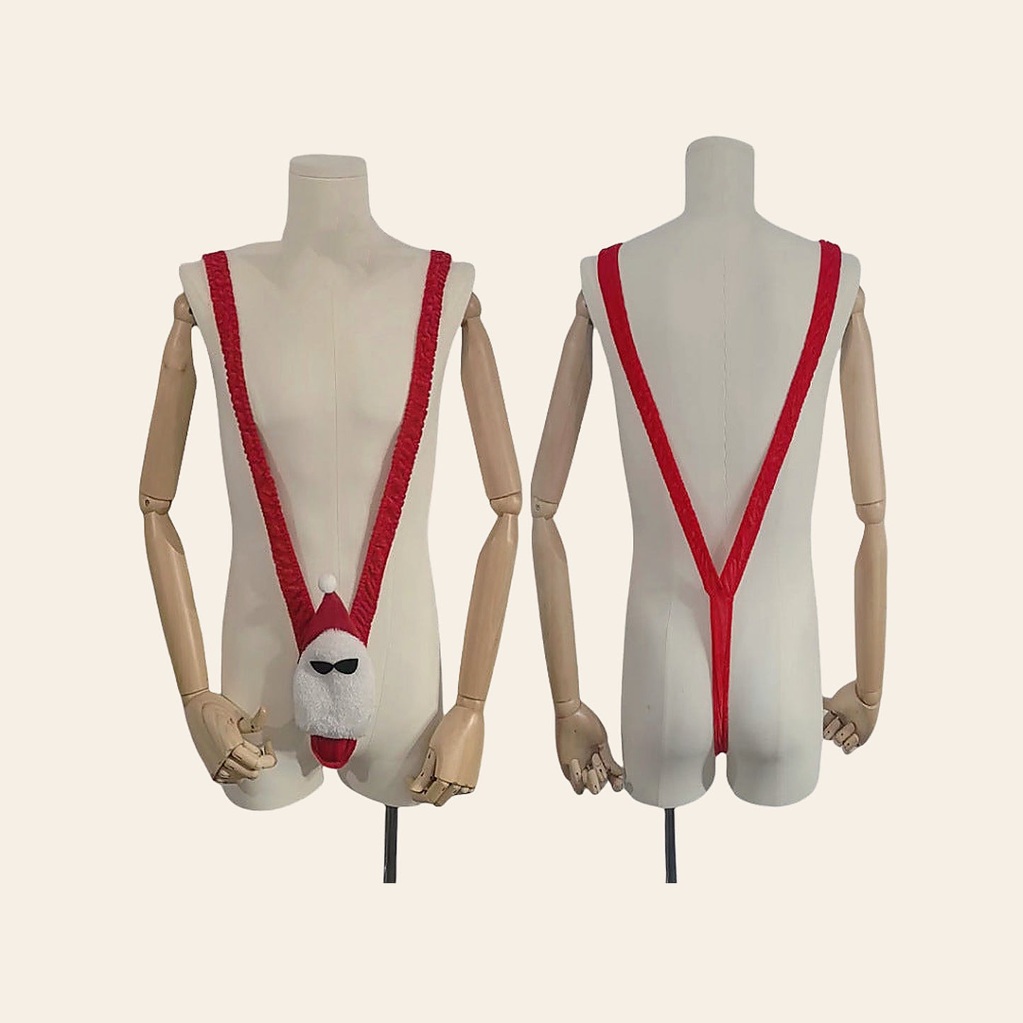 Men's novelty Santa V-string thong in red and white shown front and back on mannequin forms, on a soft beige background