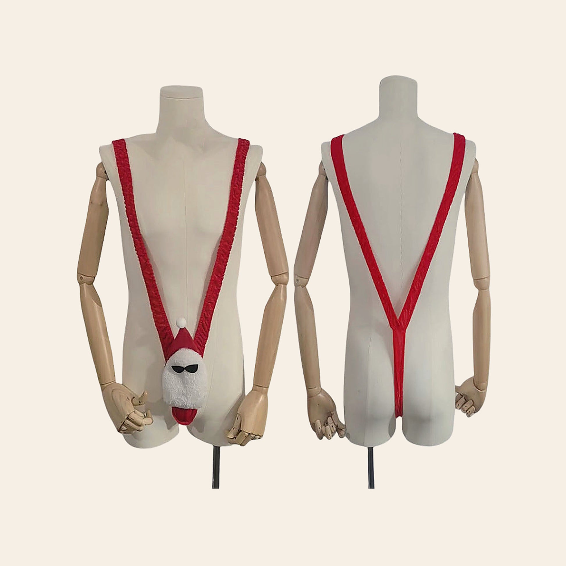 Men's novelty Santa V-string thong in red and white shown front and back on mannequin forms, on a soft beige background