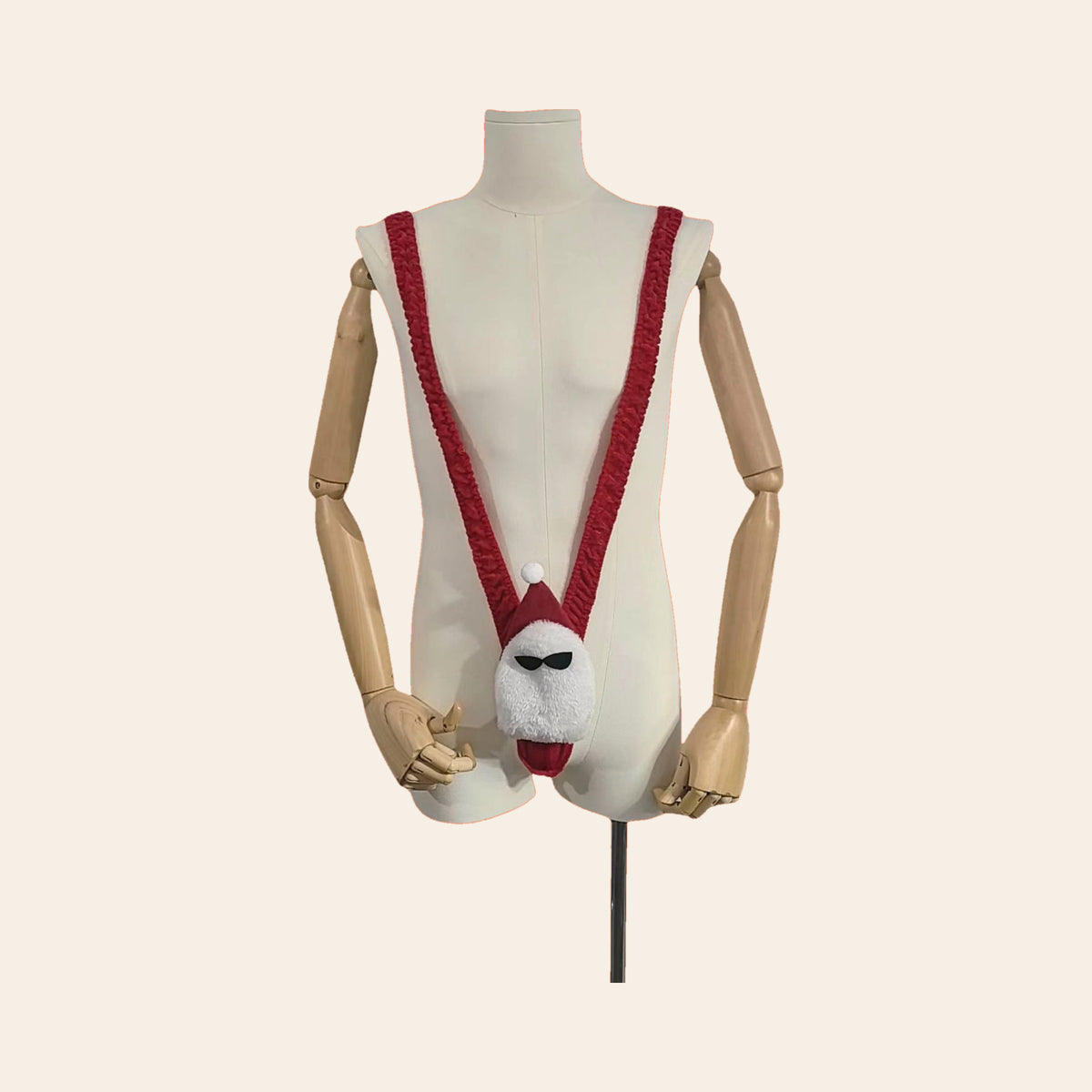 Santa V-string thong on a mannequin, front view: red straps with a white Santa-face pouch, on a soft beige background — Femme Bliss