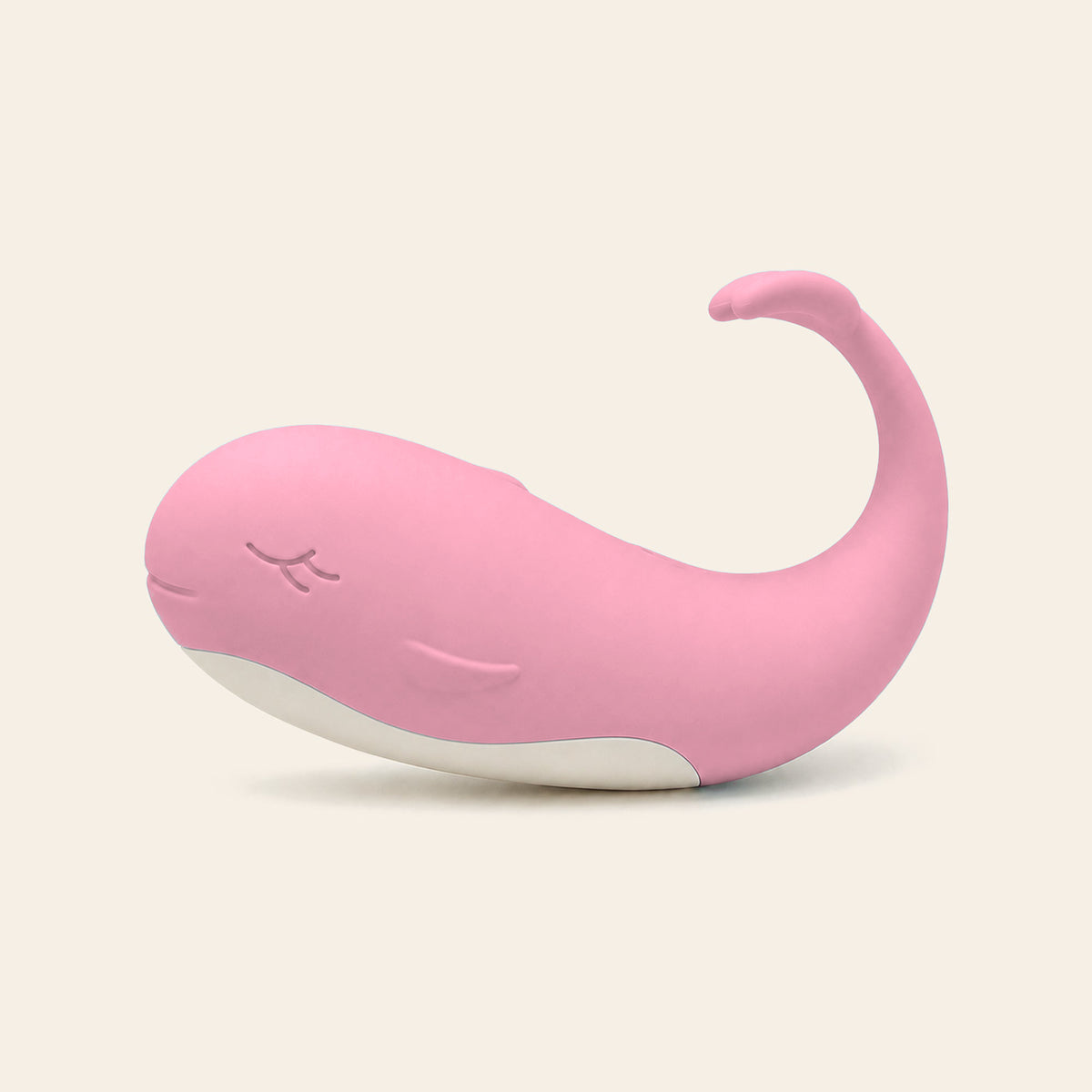 Pale pink whale-shaped silicone wearable vibrating egg on a soft beige background — Femme Bliss TidalBliss