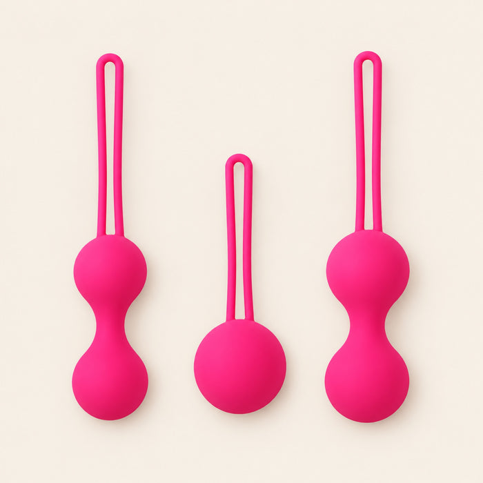 BloomCore rose-pink three-piece set with one single-ball and two double-ball weights, each with a retrieval loop, on a beige background.