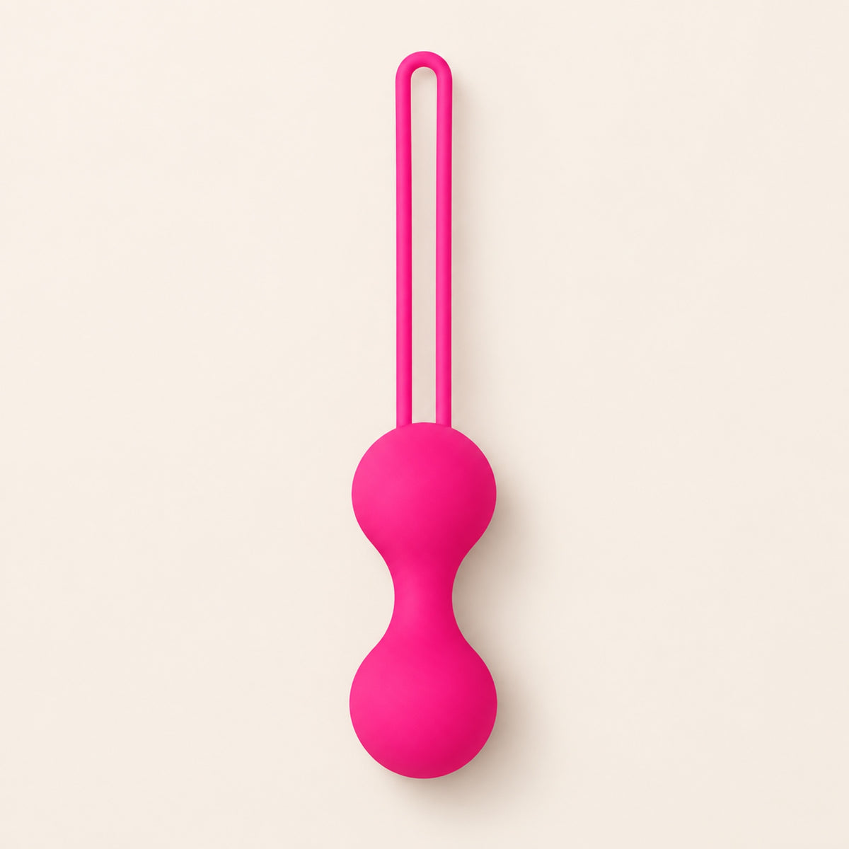 BloomCore rose-pink connected double-ball weight with an integrated retrieval loop on a beige background.